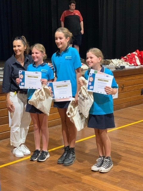 A group of girls holding certificates Description automatically generated